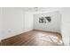 Bright bedroom with wood-look floors, ceiling fan, and window at 831 Maple Ct # 303, Dunedin, FL 34698