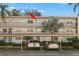 Condo building exterior showing building entrance and parking at 831 Maple Ct # 303, Dunedin, FL 34698