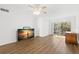 Living room features wood-look floors and a view to balcony at 831 Maple Ct # 303, Dunedin, FL 34698