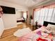 Second bedroom with a twin bed and mirrored closet doors at 8616 Pinafore Dr, New Port Richey, FL 34653