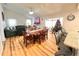 Bright dining room features hardwood floors and a wood table with seating for six at 8616 Pinafore Dr, New Port Richey, FL 34653