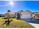 Single-story home with a two-car garage and landscaped lawn at 8616 Pinafore Dr, New Port Richey, FL 34653