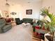Spacious living room with sectional sofa, hardwood floors, and a fireplace at 8616 Pinafore Dr, New Port Richey, FL 34653