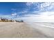 Expansive beach view with light waves and blue sky at 104 159Th Ave, Redington Beach, FL 33708