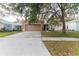 Two-story house with tan exterior, attached garage, and landscaping at 10438 Blackmore Dr, Tampa, FL 33647