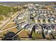 Aerial view of a community with many houses and green space at 10711 Old Sycamore Loop, Land O Lakes, FL 34638