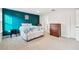 Bedroom with teal accent wall and ensuite bath at 10711 Old Sycamore Loop, Land O Lakes, FL 34638