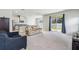 Spacious living room with light gray carpeting and patio access at 10711 Old Sycamore Loop, Land O Lakes, FL 34638
