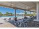 Relaxing pool area with tables, chairs, and umbrellas at 10711 Old Sycamore Loop, Land O Lakes, FL 34638