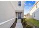Gray side entrance with walkway and landscaping at 10711 Old Sycamore Loop, Land O Lakes, FL 34638