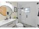 Modern bathroom with frameless shower, stylish vanity, and patterned tile floor at 1206 E Osborne Ave, Tampa, FL 33603