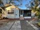 White single story house with screened porch and mature trees at 1308 E Caracas St, Tampa, FL 33603