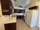 Kitchen with dark brown cabinets and white appliances at 1308 E Caracas St, Tampa, FL 33603