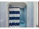 Bathroom with shower/tub and blue striped curtain at 1401 Cordova Grn, Seminole, FL 33777