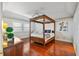 Spacious bedroom with four-poster bed and hardwood floors at 1401 Cordova Grn, Seminole, FL 33777