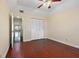 Bedroom with wood floors and access to a hallway at 1401 Cordova Grn, Seminole, FL 33777