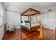 Bedroom with four-poster bed, hardwood floors, and chair at 1401 Cordova Grn, Seminole, FL 33777
