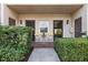 Inviting front patio with small table and chairs, perfect for relaxing at 1401 Cordova Grn, Seminole, FL 33777