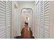 Clean hallway with hardwood floors and built-in storage at 1401 Cordova Grn, Seminole, FL 33777