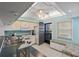 Updated kitchen with white cabinets, breakfast bar, and built-in bench at 1401 Cordova Grn, Seminole, FL 33777