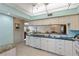 Bright kitchen with white cabinets, granite counters, and a breakfast nook at 1401 Cordova Grn, Seminole, FL 33777