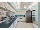 Well-equipped kitchen featuring white cabinetry and a breakfast bar at 1401 Cordova Grn, Seminole, FL 33777