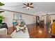 Open and airy living room with hardwood floors and a view of the dining area at 1401 Cordova Grn, Seminole, FL 33777