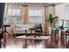 Bright living room with hardwood floors, comfy seating, and large windows at 1401 Cordova Grn, Seminole, FL 33777