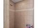 Clean shower with beige tile and chrome shower head at 1401 Cordova Grn, Seminole, FL 33777