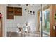 Relaxing sunroom with white walls, terracotta flooring, and sliding glass doors at 1401 Cordova Grn, Seminole, FL 33777