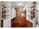 Large walk-in closet with wood paneling and shelving at 1401 Cordova Grn, Seminole, FL 33777