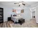 Bedroom with ceiling fan, wood-look floors, and built-in shelving at 1449 Highland Ridge Cir, Brandon, FL 33510