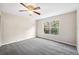 Bright bedroom with ceiling fan and grey carpet at 1550 Firewheel Dr, Wesley Chapel, FL 33543