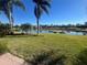Serene backyard with lake view and lush grass at 15731 Crystal Waters Dr, Wimauma, FL 33598