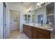 Double vanity bathroom with a large mirror and additional bathroom access at 15731 Crystal Waters Dr, Wimauma, FL 33598