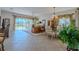 Spacious dining area with glass table and chandelier at 15731 Crystal Waters Dr, Wimauma, FL 33598