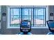 Cardio machines facing tranquil lake view at 15731 Crystal Waters Dr, Wimauma, FL 33598