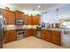 Open kitchen features stainless steel appliances and granite countertops at 15731 Crystal Waters Dr, Wimauma, FL 33598