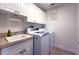 Bright laundry room with washer, dryer, and cabinets at 15731 Crystal Waters Dr, Wimauma, FL 33598