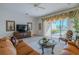 Spacious living room with leather sofas and glass coffee table at 15731 Crystal Waters Dr, Wimauma, FL 33598