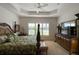 Large main bedroom with a king-size bed, plantation shutters, and a water view at 15731 Crystal Waters Dr, Wimauma, FL 33598