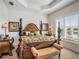 King-size bed, plantation shutters, and a view from this main bedroom at 15731 Crystal Waters Dr, Wimauma, FL 33598
