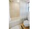 Simple bathroom with shower/tub combo and wood stool at 1655 Canopy Oaks Blvd, Palm Harbor, FL 34683