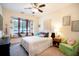 Bright bedroom with window seat and green accent chair at 1655 Canopy Oaks Blvd, Palm Harbor, FL 34683