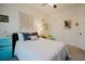 Cozy bedroom with comfortable bedding and a teal accent at 1655 Canopy Oaks Blvd, Palm Harbor, FL 34683