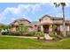 Two-story house with landscaped yard, stone accents, and palm trees at 1655 Canopy Oaks Blvd, Palm Harbor, FL 34683