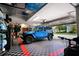 Garage with blue Jeep Wrangler, bicycle, and checkered floor at 1655 Canopy Oaks Blvd, Palm Harbor, FL 34683