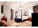 Spacious main bedroom with canopy bed and TV at 1655 Canopy Oaks Blvd, Palm Harbor, FL 34683