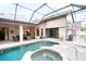 Lush backyard oasis with a screened pool and spa at 1655 Canopy Oaks Blvd, Palm Harbor, FL 34683