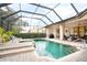 Relaxing pool and spa area with a screened enclosure at 1655 Canopy Oaks Blvd, Palm Harbor, FL 34683